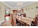 Formal dining room with elegant chandelier and decorative china cabinet at 2212 Barton Mill Ct, North Las Vegas, NV 89084