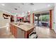 Open kitchen with granite countertops, stainless steel appliances, and an adjacent outdoor patio at 2212 Barton Mill Ct, North Las Vegas, NV 89084