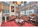 Ornate living room featuring luxurious seating, chandelier, and dramatic window treatments at 2212 Barton Mill Ct, North Las Vegas, NV 89084