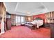 Spacious primary bedroom with tray ceiling, sitting area, and carpet flooring at 2212 Barton Mill Ct, North Las Vegas, NV 89084