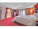 Bright primary bedroom boasts a tray ceiling, large windows and ensuite bathroom at 2212 Barton Mill Ct, North Las Vegas, NV 89084