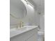 Modern bathroom with gold fixtures, sleek vanity, decorative mirror, and a shower at 2251 Wigwam Pkwy # 716, Henderson, NV 89074