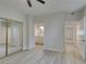 Bedroom with ensuite bathroom, features mirrored closet doors, neutral walls, and light hardwood flooring at 2251 Wigwam Pkwy # 716, Henderson, NV 89074