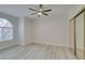 Bright bedroom with a window, mirrored closet doors, neutral walls, and ceiling fan at 2251 Wigwam Pkwy # 716, Henderson, NV 89074
