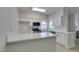 Updated kitchen featuring quartz counters, modern appliances, and white cabinetry at 2251 Wigwam Pkwy # 716, Henderson, NV 89074