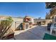 Backyard features a brick grill, mature plantings, and a patio with ample seating space at 2375 Rawhide St, Las Vegas, NV 89119