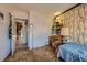 Bedroom featuring patterned wallpaper, closet, and desk with lamps, creates a cozy ambiance at 2375 Rawhide St, Las Vegas, NV 89119