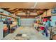 Spacious garage with exposed beams, a ceiling fan, and plenty of storage shelves for organization at 2375 Rawhide St, Las Vegas, NV 89119