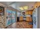 Efficient kitchen featuring tile floors, wood cabinets, stainless steel appliances, and a sliding glass door to backyard at 2375 Rawhide St, Las Vegas, NV 89119
