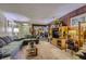 Cozy living room featuring wood-paneled walls, comfortable sofas, carpeted floors, and ample natural light at 2375 Rawhide St, Las Vegas, NV 89119