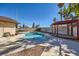 Backyard pool with a covered patio, landscaping, and the home exterior creates an inviting outdoor space at 2375 Rawhide St, Las Vegas, NV 89119