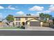 Charming two-story home with a tan exterior, brick accents, and well-manicured front lawn at 2402 El Cid Ct, Henderson, NV 89014