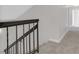 This hallway features carpeted floors and black metal railing at 2402 El Cid Ct, Henderson, NV 89014