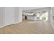 Bright kitchen with light wood floors, double doors, and an island countertop, and a view of the backyard at 2402 El Cid Ct, Henderson, NV 89014