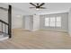 Bright living room featuring modern light wood flooring, a ceiling fan, and a large window at 2402 El Cid Ct, Henderson, NV 89014