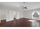 Spacious bedroom with ceiling fan, dark floors, and large windows providing ample natural light at 2405 Esteem Ridge Dr, Henderson, NV 89052