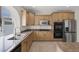 Well-lit kitchen featuring granite counters, stainless appliances, and ample cabinet space at 2405 Esteem Ridge Dr, Henderson, NV 89052