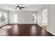 Living room with dark wood floors, natural light, and arched doorway at 2405 Esteem Ridge Dr, Henderson, NV 89052
