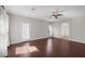 Living room with dark wood floors, door to balcony, and bathroom view at 2405 Esteem Ridge Dr, Henderson, NV 89052