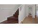 Staircase with dark wood steps and white risers and handrail at 2405 Esteem Ridge Dr, Henderson, NV 89052
