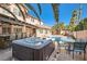 This backyard features a hot tub, a pool, and a covered patio with seating at 2529 Vera Cruz Cir, Henderson, NV 89074