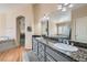 Bathroom with granite countertop, wood cabinets and large mirrors at 2529 Vera Cruz Cir, Henderson, NV 89074