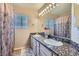 Bathroom featuring double sinks with granite countertops and a large mirror at 2529 Vera Cruz Cir, Henderson, NV 89074