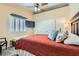 Cozy bedroom with plush bed, ceiling fan, plantation shutters, and neutral decor at 2529 Vera Cruz Cir, Henderson, NV 89074