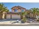 Beautiful two-story home featuring a three-car garage, tile roof, and desert landscaping at 2529 Vera Cruz Cir, Henderson, NV 89074