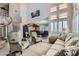 Bright living room with large windows, staircase, and open floor plan leading to the dining area at 2529 Vera Cruz Cir, Henderson, NV 89074