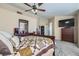 Spacious primary bedroom includes TV, ceiling fan, ensuite bathroom, and closet at 2529 Vera Cruz Cir, Henderson, NV 89074
