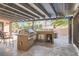 This outdoor kitchen features stainless steel appliances, a grill, and a built-in cooler at 2529 Vera Cruz Cir, Henderson, NV 89074