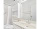 Bright bathroom with white tile, cabinets, and a shower-tub combo at 2647 Jacyra Ave, Las Vegas, NV 89121