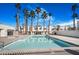 Large community pool offers a cool retreat with surrounding palm trees and ample space to relax at 2647 Jacyra Ave, Las Vegas, NV 89121