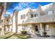 Inviting townhome featuring a well-maintained lawn, mature trees, and charming exterior details at 2647 Jacyra Ave, Las Vegas, NV 89121