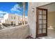 View of a patio with an open door showcasing the building exterior and blue sky at 2647 Jacyra Ave, Las Vegas, NV 89121