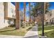 Landscaped walkway offers a tranquil path through the community with mature trees and lush greenery at 2647 Jacyra Ave, Las Vegas, NV 89121