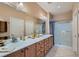 Spacious bathroom features double sinks, shower, and ample storage at 2705 Cuckoo Shrike Ave, North Las Vegas, NV 89084