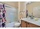 Clean bathroom featuring a shower-tub combo, solid surface vanity, and ample lighting at 2705 Cuckoo Shrike Ave, North Las Vegas, NV 89084