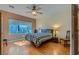 Cozy bedroom with ceiling fan, wood floors, and backyard views at 2705 Cuckoo Shrike Ave, North Las Vegas, NV 89084