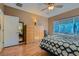 Bright bedroom features wood floors, an en suite bathroom, and large wardrobe at 2705 Cuckoo Shrike Ave, North Las Vegas, NV 89084