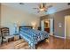 Inviting bedroom with ceiling fan, wood floors, and en suite bathroom at 2705 Cuckoo Shrike Ave, North Las Vegas, NV 89084