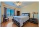 Comfortable bedroom features a ceiling fan, wood floors, and a cozy sleeping space at 2705 Cuckoo Shrike Ave, North Las Vegas, NV 89084