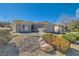 Charming single-story home featuring desert landscaping and a welcoming two-car garage at 2705 Cuckoo Shrike Ave, North Las Vegas, NV 89084