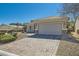 A single-story home with a brick driveway and desert landscaping at 2705 Cuckoo Shrike Ave, North Las Vegas, NV 89084