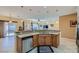 Open kitchen features stainless steel appliances, granite counters, and modern lighting at 2705 Cuckoo Shrike Ave, North Las Vegas, NV 89084