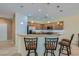 Well-lit kitchen features stainless steel appliances, granite countertops, and a breakfast bar at 2705 Cuckoo Shrike Ave, North Las Vegas, NV 89084