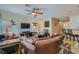 Cozy living room features tile flooring, a ceiling fan, and comfortable seating arrangements at 2705 Cuckoo Shrike Ave, North Las Vegas, NV 89084