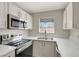 Well-equipped kitchen featuring stainless appliances, ample counter space, white cabinets and a double basin sink at 2966 Juniper Hills Blvd # 204, Las Vegas, NV 89142