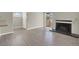 Spacious living room with laminate flooring, fireplace, and doors leading to the patio at 2966 Juniper Hills Blvd # 204, Las Vegas, NV 89142
